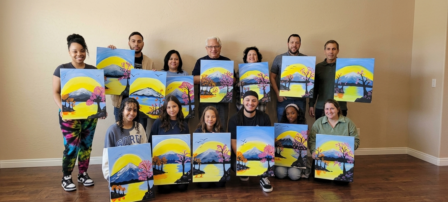 A group proudly displaying their finished landscape paintings