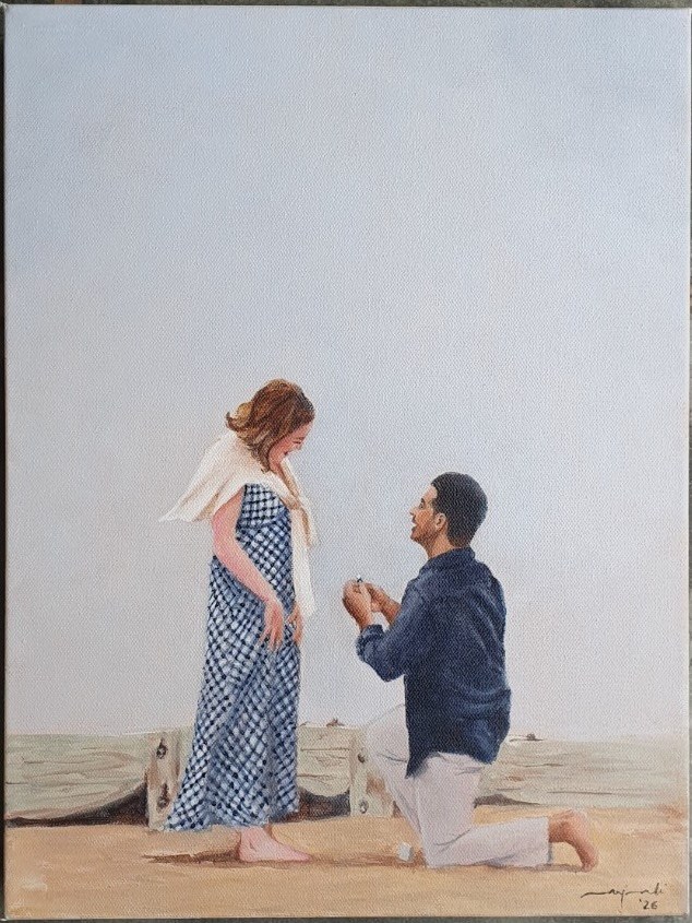 A beach proposal, with a man kneeling before a woman