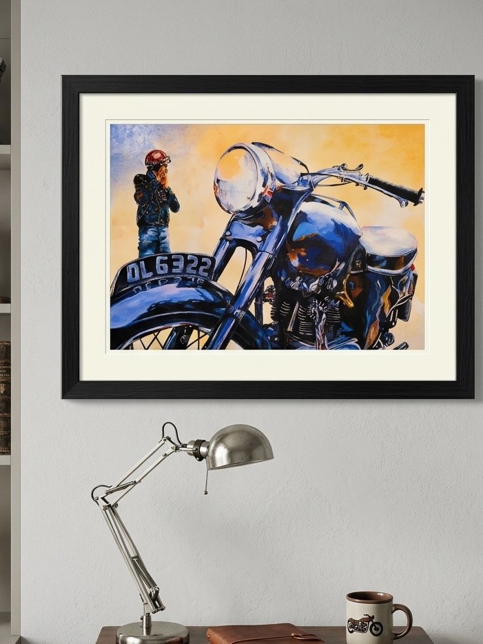 Framed portrait of a man beside a blue motorcycle