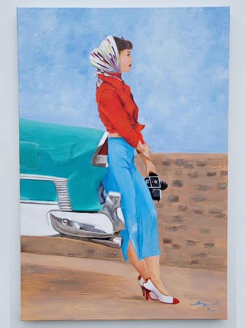 Woman in a red jacket and blue skirt beside a blue car